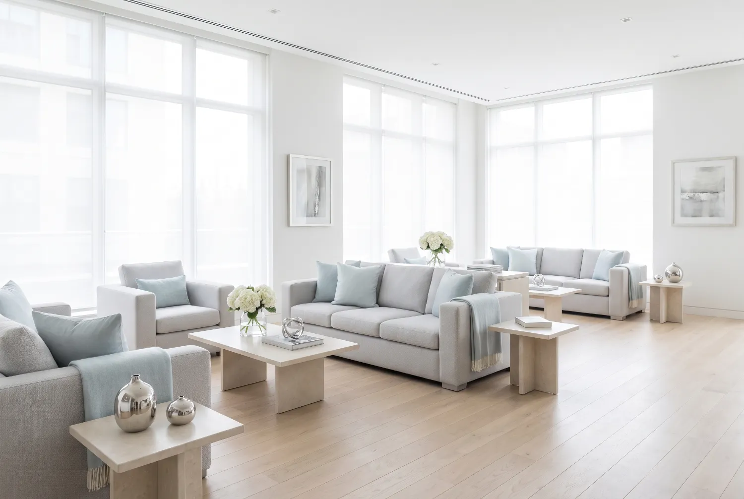 Empty members club lounge with pale sofas and tall bright windows