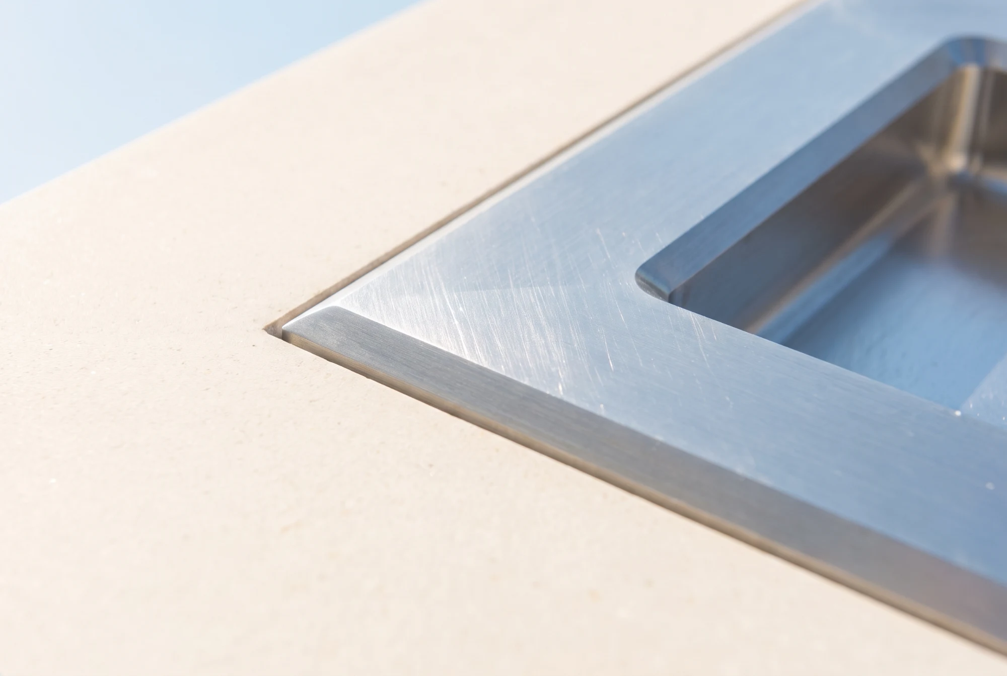 Brushed silver fitting set into pale limestone