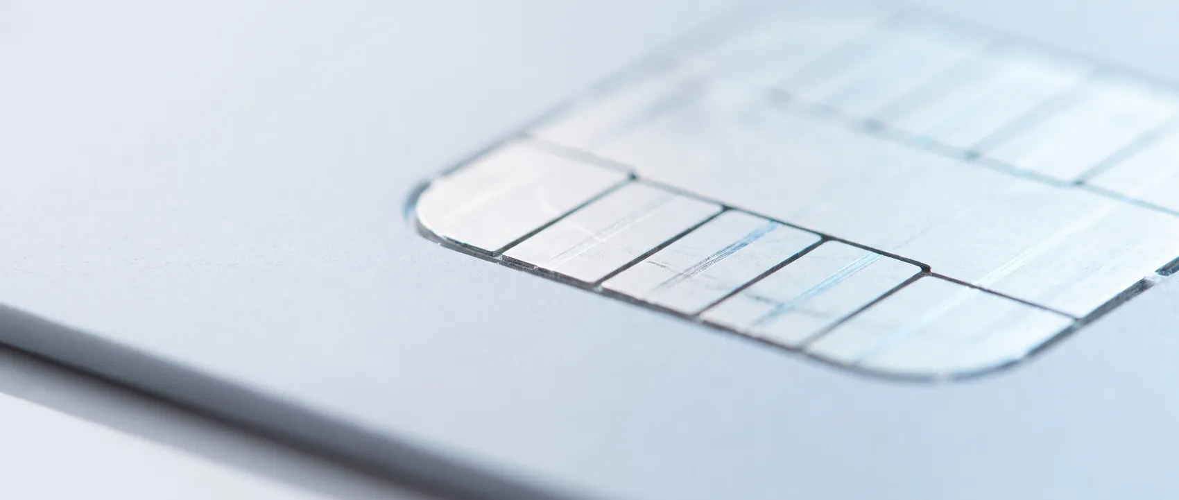 Macro detail of a bank card chip contact plate in cool light