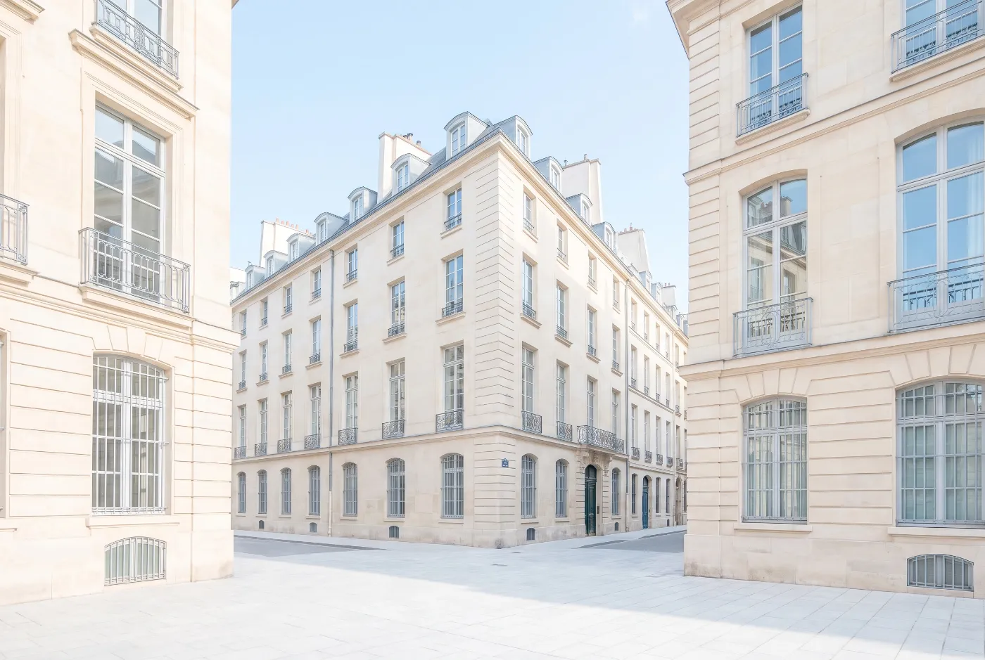 Quiet Paris street corner of pale limestone in clear morning light